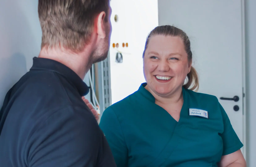 Zahnärztin Danielle Rudolph lächelnd mit einem Patienten